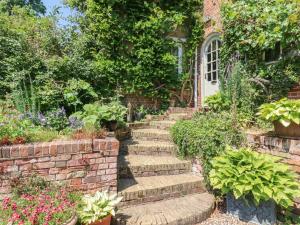 a garden with stairs leading up to a house at The Gate House in Colchester