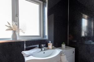 a bathroom with a sink and a window at Broome Road in Durham +16 photos
