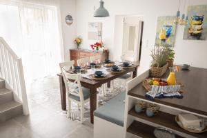 a dining room with a table and chairs in a kitchen at Villa GreenTree - with Private Pool close to Budapest in Budakalász