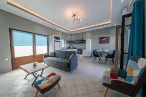 a living room with a couch and a table at Luxury Sea View Apartment in Kolimvari in Kolymvari