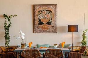 a dining room with a table and a painting on the wall at Kenta Beach Hotel in Agios Ioannis Pelio