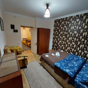 a bedroom with a bed and a living room at Buddha apartment in Tbilisi City