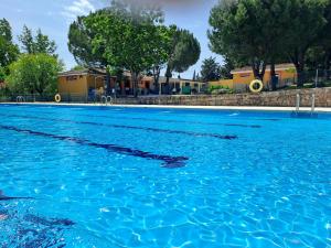 a large pool of blue water with trees in the background at Casa El Frenazo in Garciotum