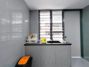 a small kitchen with a sink and a window at Plaza Berjaya By Manhattan Group in Kuala Lumpur