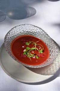 a bowl of soup on a plate on a table at Hotel Rural Sant Ignasi in Ciutadella