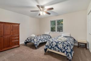 a bedroom with two beds and a ceiling fan at The Big Blue Lakehouse in Berrien Springs