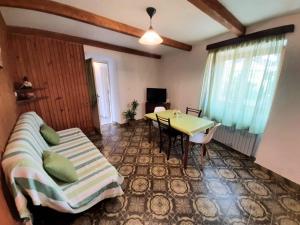 a bedroom with a bed and a table in a room at Vacation House Calluna in Vrisnik
