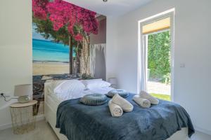 a bedroom with a bed with pillows and a window at Apartamenty Olchowa z tarasem w spokojnej okolicy - Dream Apart in Ustroń