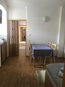 a dining room with a table and chairs and a kitchen at Penzion u Formana in Stráž nad Nežárkou