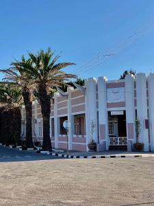 a large building with palm trees in front of it at The Hanover Luxury Hotel in Hanover