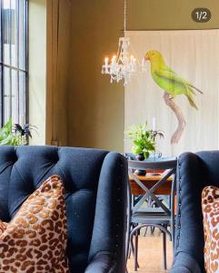 a living room with a couch and a bird on the wall at The Hanover Luxury Hotel in Hanover