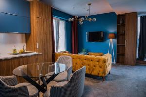 a living room with a couch and a glass table at Sky Deluxe 3 Fitness & Spa in Skopje