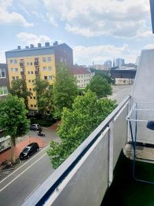 a balcony with a view of a street and buildings at FEE Apartment 1 Bremerhaven in Bremerhaven