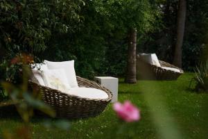 two wicker chairs sitting in the grass in a yard at Lemon Tree Hotel in Parga
