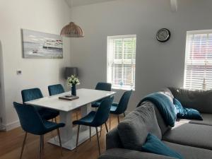 a living room with a table and chairs and a couch at The Bakery Flat, Frogmore in Kingsbridge