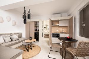 a living room with a couch and a table at Mnḗmē Suites & Villas in Kastrí