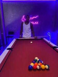 a man standing next to a pool table at Thai Cozy House in Bangkok