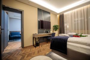 a hotel room with a bed and a desk at Avalon Resort & SPA in Miskolctapolca