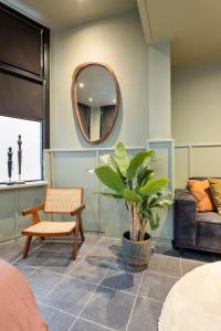 een woonkamer met een spiegel en een plant bij 't Hoekje in Enschede