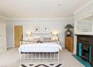 a bedroom with a bed and a fireplace at La Maison De La Mer, Worthing in Worthing