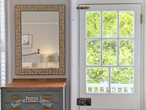 a mirror on a wall next to a window at La Maison De La Mer, Worthing in Worthing +29 photos