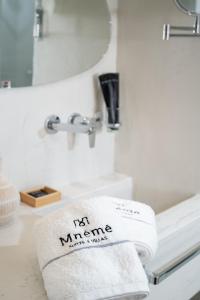 a bathroom with a white towel on a sink at Mnḗmē Suites & Villas in Kastrí