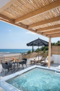 an outdoor patio with a swimming pool and a wooden pergola at Mnḗmē Suites & Villas in Kastrí