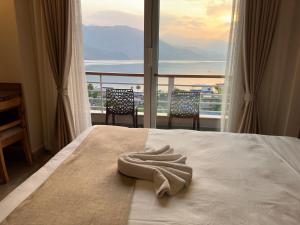 a hotel room with a bed with a view of the ocean at Urban Boutique Hotel Pokhara in Pokhara