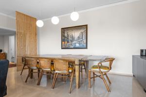 a dining room with a wooden table and chairs at Cascais by the Sea in Estoril