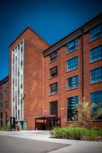 a large red brick building with a large window at MONTOWNIA Lofts & Experience in Gdańsk