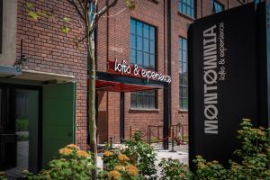 a sign in front of a brick building at MONTOWNIA Lofts & Experience in Gdańsk