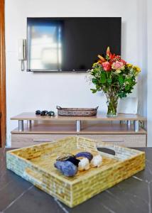 a table with a tray of food and a vase with flowers at Electra apartment Agia Triada in Agia Triada