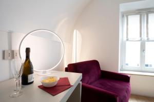 Habitación con botella de vino y silla en Le Stanze Del Savonarola, en Ferrara
