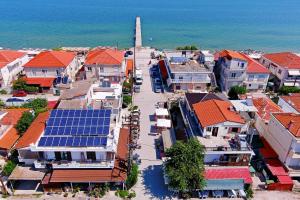 an aerial view of a town with solar panels on roofs at Electra apartment Agia Triada in Agia Triada