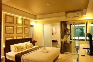 a bedroom with a bed and a television in it at The Luxury Residence in Songkhla