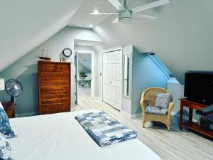 a bedroom with a bed and a ceiling fan at Sea Duck Cottage Main House in Jonesport