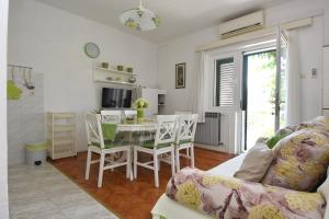 a living room with a table and a dining room at Apartments Silvija near Luke beach in Murter