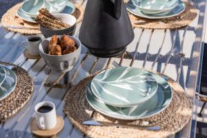 een tafel met borden en kommen met voedsel bij Arsenis Luxury Villas in Plaka