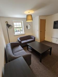a living room with a couch and a coffee table at Self contained town house in Mexborough in Mexborough
