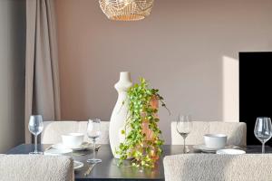 a dining room table with glasses and a vase on it at Enschede81 in Enschede