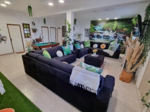 a large living room with couches and a pool table at Quinta do Ribeiro in Covilhã