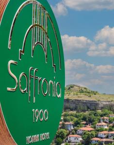 a sign for a hotel with a view of a town at Saffronia1900 Butik Otel in Safranbolu