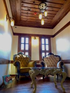 a living room with two couches and a table at Saffronia1900 Butik Otel in Safranbolu