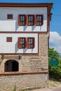 a building with windows and a sign in front of it at Saffronia1900 Butik Otel in Safranbolu