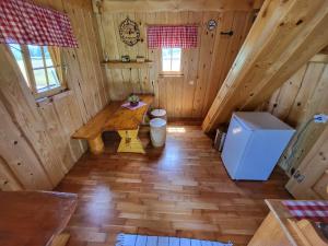 an overhead view of a cabin with a table and a refrigerator at Unique wooden holiday house in nature in Lukovica pri Domžalah