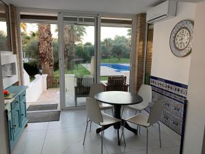 a kitchen with a table and chairs and a patio at Casa Cadi in Orihuela Costa