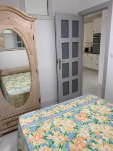 a bedroom with a bed with a large mirror at Casa Cadi in Orihuela Costa