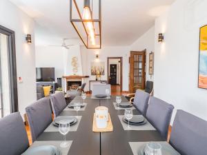 a dining room with a long table and chairs at Cubo's Beach Front Villa Benalmadena in Torremuelle