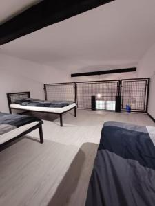 a room with two beds and a balcony at Agroturystyka "Apartament na wsi" Bory Tucholskie in Szlachta