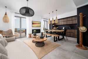 a living room with a couch and a table at Mnḗmē Suites & Villas in Kastrí
